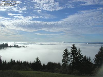 Fog fills the entire valley moving upriver toward the South. Steam plume center/right is the pulp & paper mill in St. Helens, OR